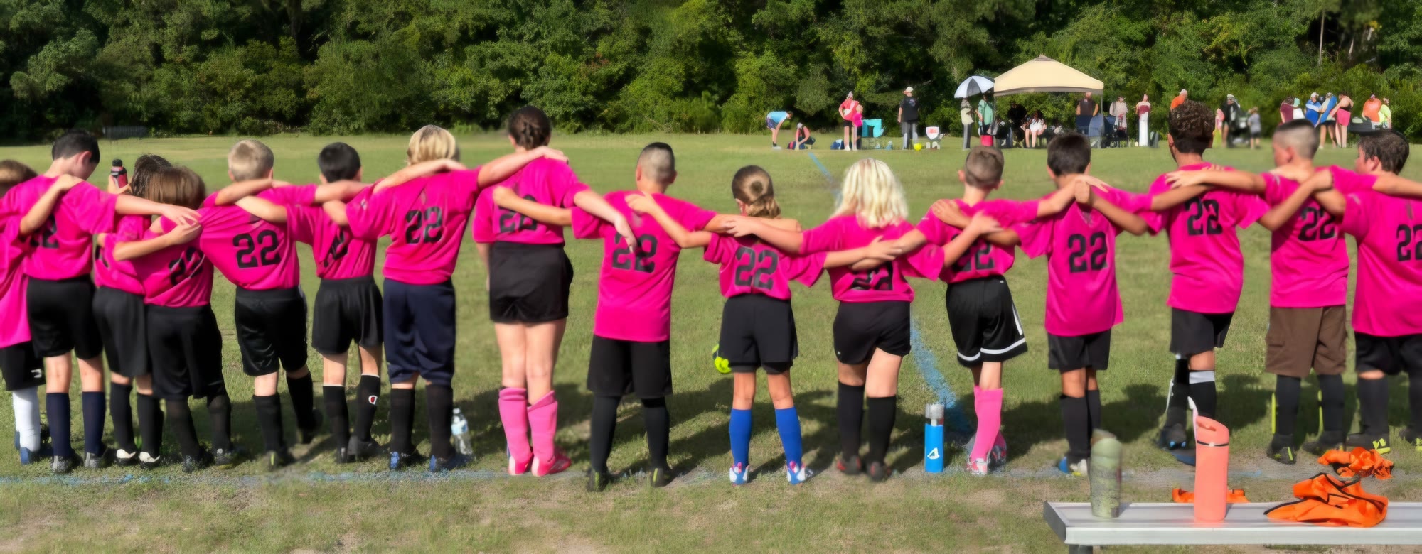 Falcons United players standing arm in arm along the touchline