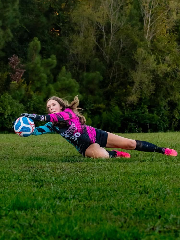 Falcons United goalkeeper making a diving save