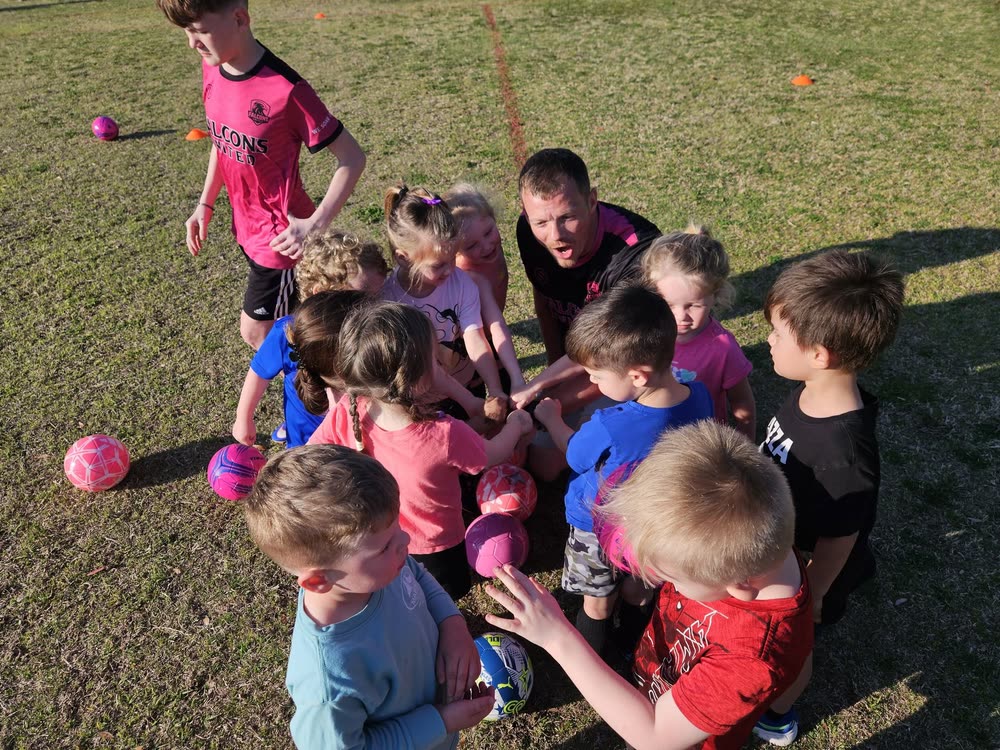 Falcons United REC players in a huddle