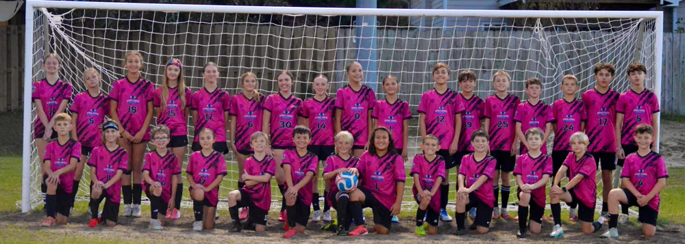 The Falcons United Classic team lined up in front of the goal
